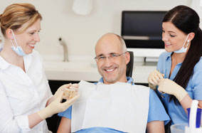 a patient at durham dental solutions being shown a model