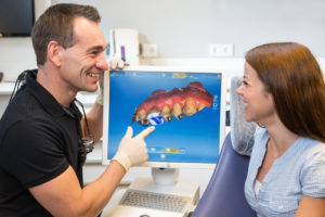 the dentist at durham implant solutions going over a digital smile design with his patient