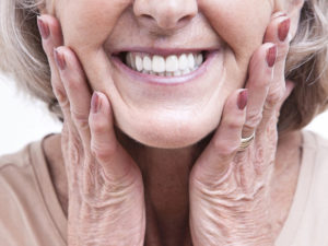 an elderly lady smiling with her new dentures