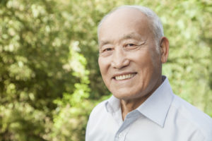 a man smiling after receiving dental implants